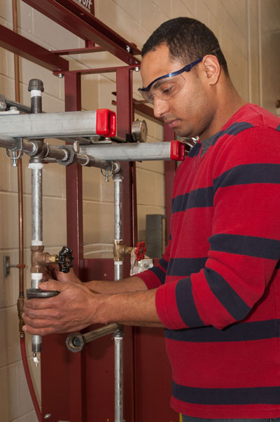 adult student in plumbing lab