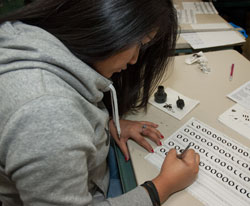 A student practices calligraphy in the Advertising Design and Commercial Art class.