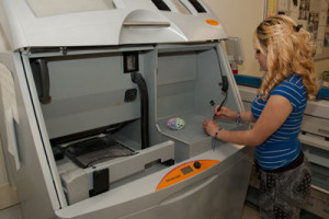 A student operates a 3D printer.