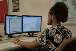 A student uses two monitors in computerized drafting class.
