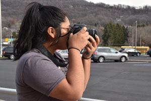 Advertising student using a digital SLR camera