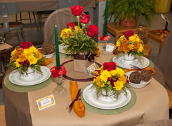 A table display showcases four different flower arrangements.