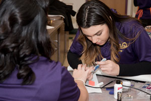 Learning to perform a manicure in Cosmetology class.