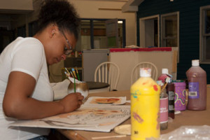 A student practices a painting technique in Painting & Decorating class.