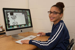 A student does design work on a computer in the Printing and Graphic Communications classroom.