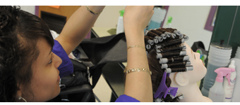 A Cosmetology student practices styling techniques.