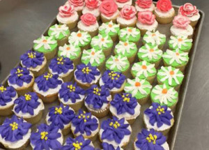 Decorated cupcakes on a tray are ready to be served at a special occasion.