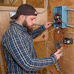 An Electrical Technology student checks his wiring with the use of a voltage meter.