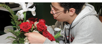A student arranges flowers in the Horticulture program.