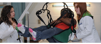 Students in Health–Nursing Careers class learn how to use the lift chair mechanism.