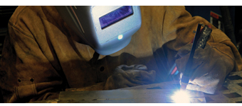 A student practices welding in the Welding and Metal Fabrication shop.