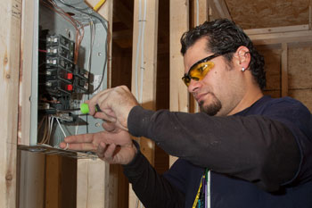adult student wiring a service panel