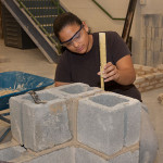 student building a block wall