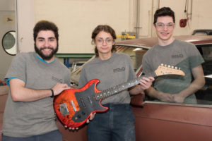 Auto Body Repair students and the guitar they refurbished