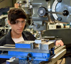 An RMCTC 3D Manufacturing student operates a milling machine.