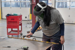 A student at work in the Auto Body Repair shop.