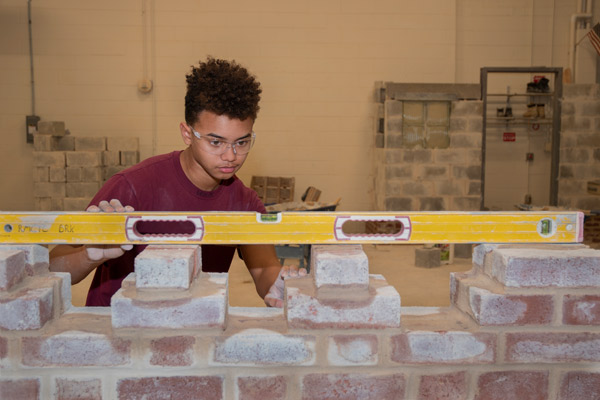 An RMCTC Bricklaying student builds a wall.