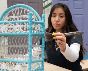 A student in Painting & Interior Design works on a project.