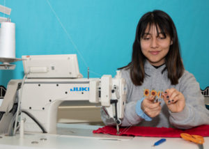 A student in the Sewing & Clothing Manufacturing program works on a project.