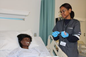 Students demonstrating oral care with a patient
